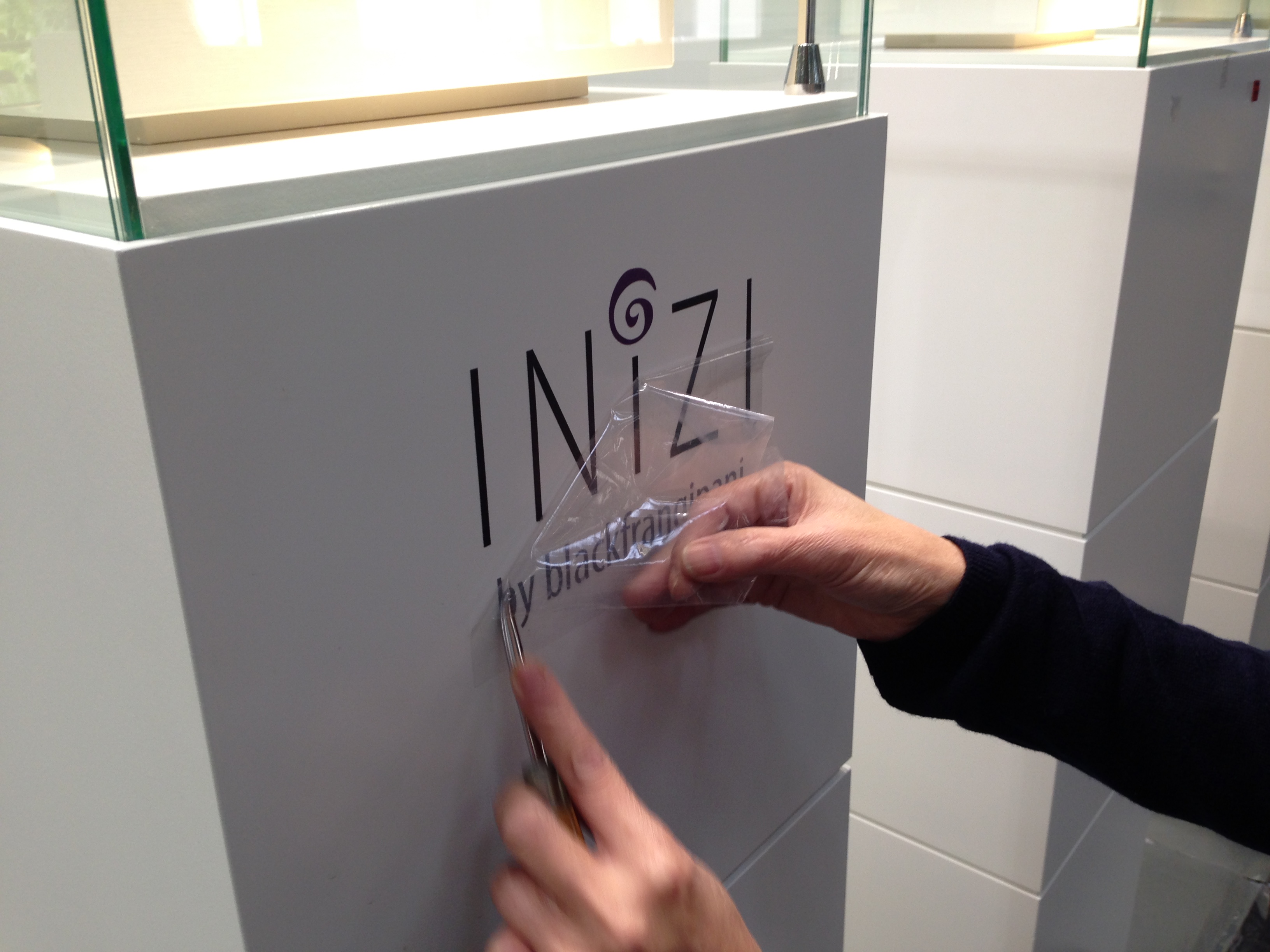 Setting up logo on display showcases at Inhorgenta Munich