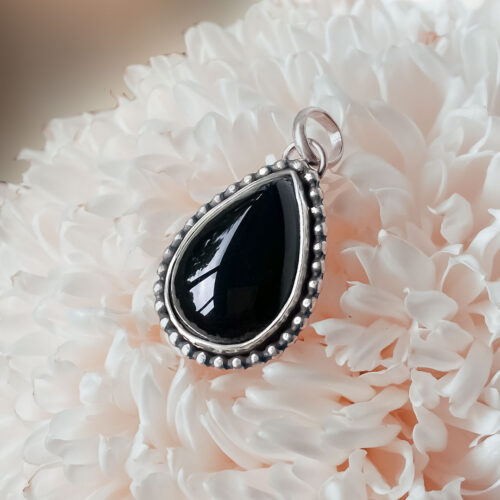 A black onyx pendant with a surprise at the back.