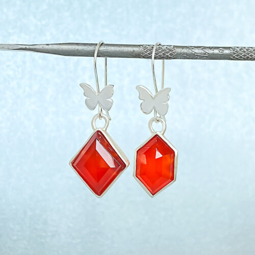 Facets in Red Earrings – Dimensional. Faceted. Sexy red. These asymmetrical earrings reflect the facets of your personality. With an element of surprise.